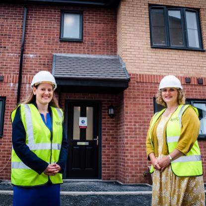 Stafford MP Theo Clarke is pictured outside the new homes with Housing Plus Group chief executive, Sarah Boden