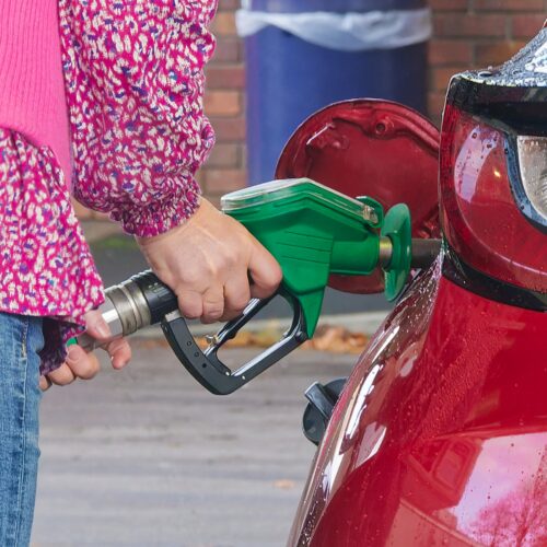Lady filling her car up with fuel