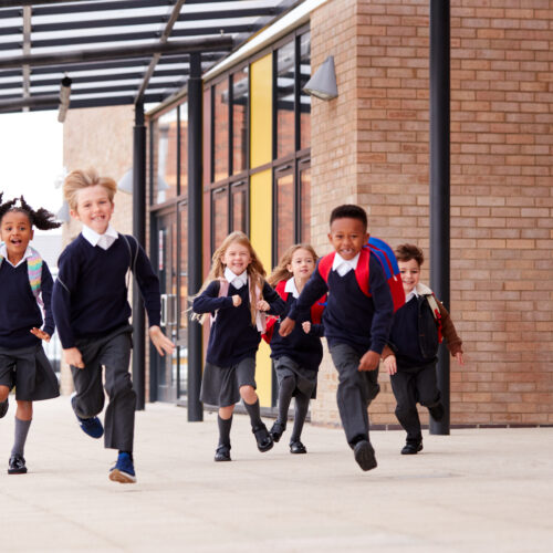 Children running into school